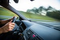 Man driving a car moving fast on a highway