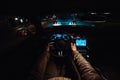 Man driving a car at the night city in car traffic chasing another car. Royalty Free Stock Photo