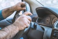 Man driving a car. Person drives a right-hand drive car