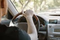 A man driving a car, rear view from the passenger compartment. Safe driving