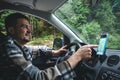 A man driving a car rides in a mountainous forest area. Royalty Free Stock Photo
