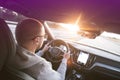 Man driving a car. Success in motion. Handsome young man driving a car. A man holds the steering wheel of a car