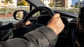 Man driving car. Unrecognizable driver holding hands on steering wheel Royalty Free Stock Photo