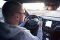 Man driving car using mobile phone texting message or calling..Driver holding smart phone while driving car on the road..People Royalty Free Stock Photo