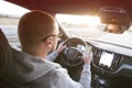 Man driving car using mobile phone texting message or calling..Driver holding smart phone while driving car on the road..People Royalty Free Stock Photo