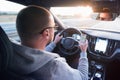 Man driving car using mobile phone texting message or calling..Driver holding smart phone while driving car on the road..People Royalty Free Stock Photo