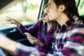 Young Man driving a car and woman searching location or gps on her smartphone Royalty Free Stock Photo