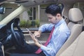 Man driving checks digital tablet for locating an address
