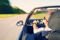 Man driving a convertible car on country road. View from inside behind the driver. man is driving at high speed on the highway. Royalty Free Stock Photo