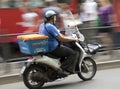 Man driving delivery scooter in city traffic Royalty Free Stock Photo