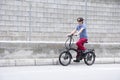 Man driving electric bike to work with dark sunglasses Royalty Free Stock Photo