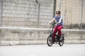 Man driving electric bike to work with dark sunglasses Royalty Free Stock Photo