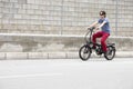 Man driving electric bike to work with dark sunglasses Royalty Free Stock Photo