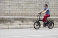 Man driving electric bike to work with dark sunglasses Royalty Free Stock Photo