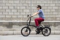 Man driving electric bike to work with dark sunglasses Royalty Free Stock Photo