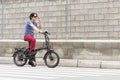 Man driving electric bike to work with dark sunglasses Royalty Free Stock Photo