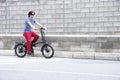 Man driving electric bike to work with dark sunglasses Royalty Free Stock Photo