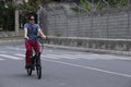 Man driving electric bike to work with dark sunglasses Royalty Free Stock Photo