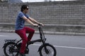 Man driving electric bike to work with dark sunglasses Royalty Free Stock Photo