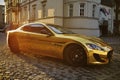 A man driving an expensive car. A man is driving, a successful man is driving a car. Golden yellow car. A man at sunset driving.