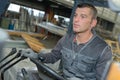 Man driving forklift inside warehouse Royalty Free Stock Photo