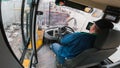 Man driving a front loader forward and backward, inside the cabin view Royalty Free Stock Photo