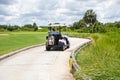 Man Driving Golf Cart on Path