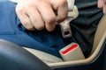 Man driving hands buckled up with seatbelt inside the car safety belt selective focus. safety driving concept