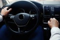 Man driving his car, closeup view of hands on steering wheel Royalty Free Stock Photo