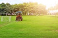 A man driving a lawn mower On a large football field, in the morning time, outdoors, gardening ideas