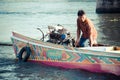 Man driving a longtail boat