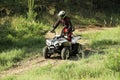 Man driving modern quad bike on sandy road. Extreme sport Royalty Free Stock Photo