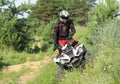 Man driving modern quad bike on sandy road near forest. Extreme sport Royalty Free Stock Photo