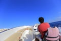 Man driving motor boat, view forward from a motor boat