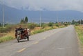 Man is driving motor tricycle on the road nearly