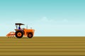 The man is driving a orange tractor. In order to plow the soil in the field. Royalty Free Stock Photo