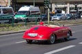 Man driving a Porsche 1600 super sports car in the streets of Berlin