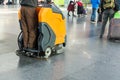 Man driving professional floor cleaning machine at airport or railway station. Floor care and cleaning service agency Royalty Free Stock Photo