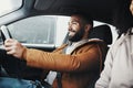 Man driving, rain and smile in city with car journey, winter travel and happiness for road trip. Guy driver Royalty Free Stock Photo