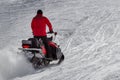 Man driving a snowmobile. Winter ski resort. winter ski suits and people riding snowmobile