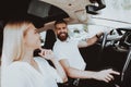 Man Is Driving A Tesla Car. Girl At Front Seat