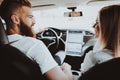 Man Is Driving A Tesla Car. Girl At Front Seat