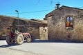 A man driving a tractor in village Sant-Esteve-de-Guialbes. Spain