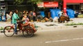 A man driving a trishaw with passenger