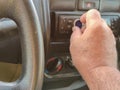 man driving using a car radio with the danger of getting distracted from driving Royalty Free Stock Photo