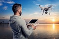 Man with drone with camera taking photos of beautiful sunset