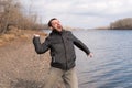 Man dropping a stone into the river Royalty Free Stock Photo