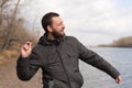 Man dropping a stone into the river Royalty Free Stock Photo