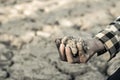 Man on a drought-stricken land in hopes of recovering.