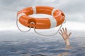 Man is drowning in ocean and is catching life buoy Royalty Free Stock Photo